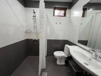 a bathroom with a toilet and a sink and a shower at Family Hotel 007 Ivan Dimitrov-Kuklata 15 Str in Sofia