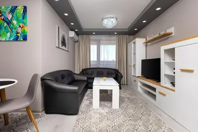 a living room with a couch and a table at Comfy Apartment with Private Parking in Plovdiv