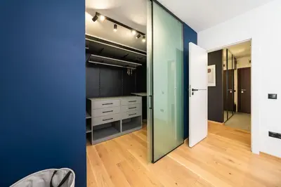 a walk in closet with a blue wall at Vitosha Apartment With Parking in Sofia