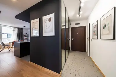 a hallway with a black wall and a door at Vitosha Apartment With Parking in Sofia