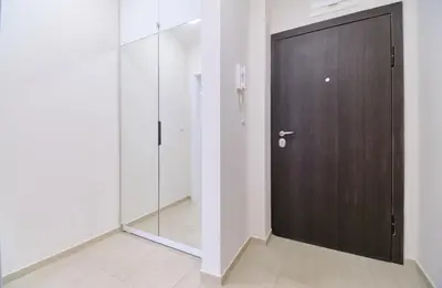 a wooden door in a room with a mirror at Cozy 1-bed Apartment in Plovdiv