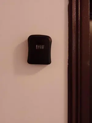 a black electrical outlet on a pink wall at Apartment for rest in Borovets in Borovets