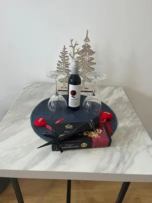 a table with two glasses and a bottle of wine at Apartment for rest in Borovets in Borovets