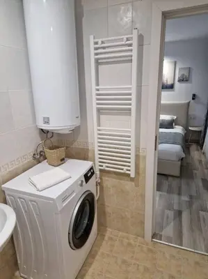 a bathroom with a washing machine and a sink at Monfort A in Bansko
