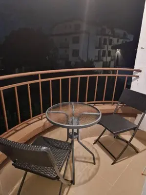a table and two chairs on a balcony with a view at Monfort A in Bansko