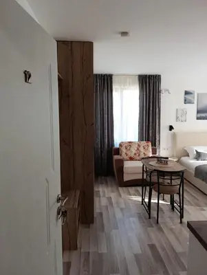 a living room with a couch and a table at Monfort A in Bansko