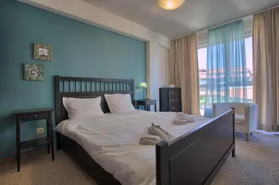 a bedroom with a large bed with shoes on it at Bansko Royal Towers - 2BD Flat with Parking by Flat Mаnager in Bansko