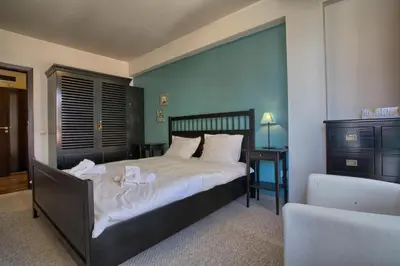 a bedroom with a large bed with white sheets at Bansko Royal Towers - 2BD Flat with Parking by Flat Mаnager in Bansko