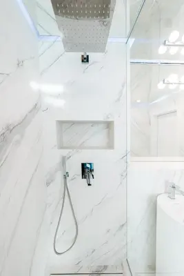 a bathroom with white marble walls and a shower at Emirates White Sensation in Sofia