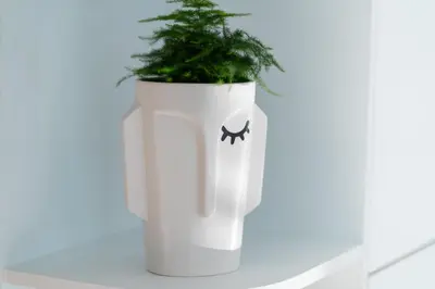 a white planter with a plant in it at Emirates White Sensation in Sofia