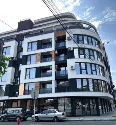 a large building with cars parked in front of it at Ultra Lux Studio Free Underground Secure Parking in Pazardzhik