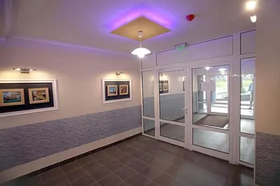 a room with a hallway with a door and paintings at Magenta Apartment with free WiFi in Sofia