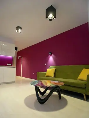 a living room with a green couch and a table at Magenta Apartment with free WiFi in Sofia