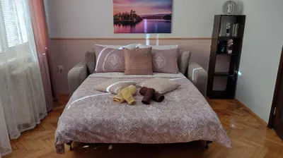 two stuffed animals sitting on top of a bed at Sofia Center Chic Suite - Separate Kitchen and Balcony in Sofia