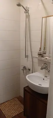 a white bathroom with a sink and a shower at Sofia Center Chic Suite - Separate Kitchen and Balcony in Sofia