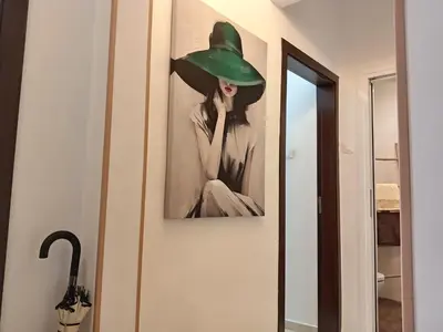 a painting of a woman wearing a green hat at Sofia Center Chic Suite - Separate Kitchen and Balcony in Sofia