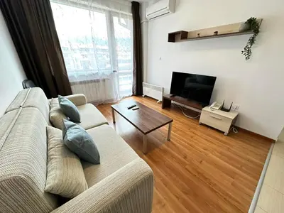 a living room with a couch and a table at Nice apartment in Belvedere Club in Bansko