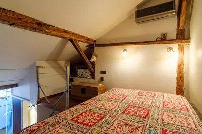 a bedroom with a bed in a attic at The Gallery - Art Studio in the Heart of Sofia by Flat Mаnager in Sofia