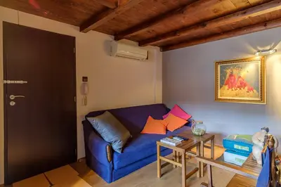 a living room with a blue couch and a table at The Gallery - Art Studio in the Heart of Sofia by Flat Mаnager in Sofia