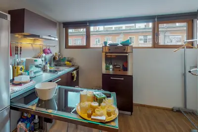 a kitchen with a glass counter with food on it at The Gallery - Art Studio in the Heart of Sofia by Flat Mаnager in Sofia