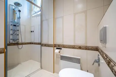 a bathroom with a shower and a toilet at Stylish Stay - 2BDR, 2BTHR+ Free Parking in Sofia