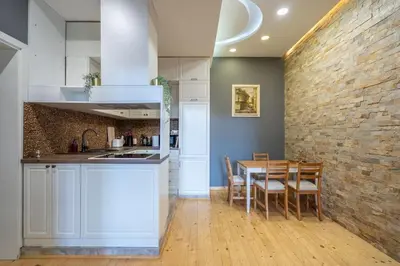 a kitchen and dining room with a brick wall at Stylish Stay - 2BDR, 2BTHR+ Free Parking in Sofia