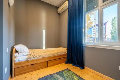 a small bedroom with a bed and a window at Stylish Stay - 2BDR, 2BTHR+ Free Parking in Sofia
