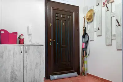 a brown door in a kitchen with a hat on the wall at Mountain Apartment in Borovets Ski Resort in Borovets
