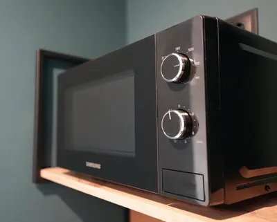 a microwave oven sitting on top of a shelf at Lily's Studio 2 by Bulgarentals - Central Sofia in Sofia