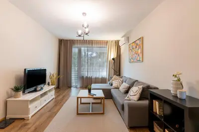 a living room with a couch and a tv at Your Place in Sofia