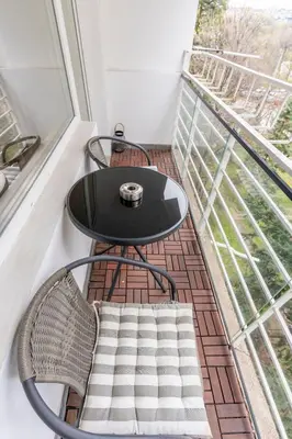 a black table and chairs on a balcony at Your Place in Sofia