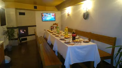 a long table with food and drinks on it at Slavina Guest House in Sapareva Banya