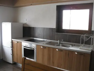 a kitchen with a sink and a stove and a refrigerator at Slavina Guest House in Sapareva Banya