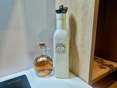 a bottle of oil and a glass jar on a shelf at Lily's Studio 3 by Bulgarentals - Central Sofia in Sofia