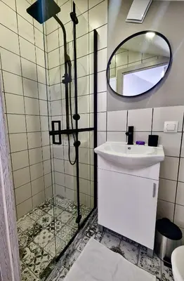 a bathroom with a sink and a mirror at Lily's Studio 1 by Bulgarentals - Central Sofia in Sofia