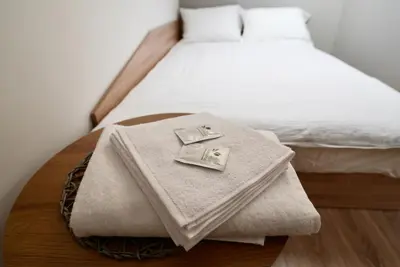 a bed with a table with towels on it at Lily's Studio 5 by Bulgarentals - Central Sofia in Sofia