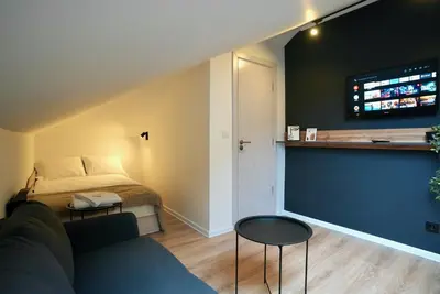 a living room with a bed and a couch at Lily's Studio 7 by Bulgarentals - Central Sofia in Sofia