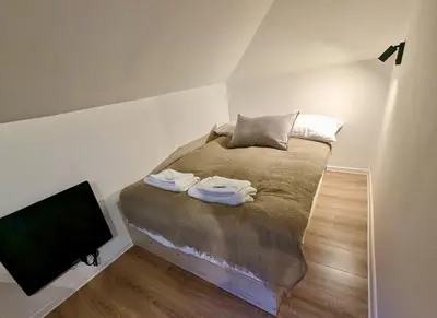 a small bedroom with a bed and a tv at Lily's Studio 7 by Bulgarentals - Central Sofia in Sofia
