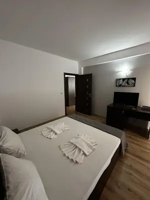 a bedroom with two white towels on a bed at Хотел Костенец in Kostenets Village