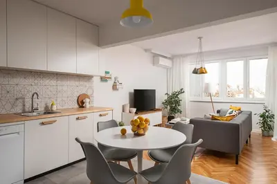 a kitchen and a living room with a table and chairs at Bright and Stylish 2BD Flat in The City Centre by Flat Mаnager in Sofia