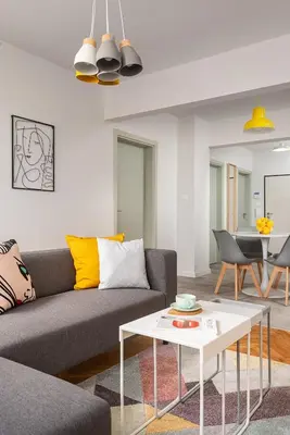 a living room with a couch and a table at Bright and Stylish 2BD Flat in The City Centre by Flat Mаnager in Sofia