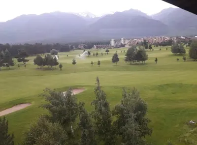 a view of a golf course with mountains in the background at Apartament by Zenit in Terra Complex B30 in Razlog