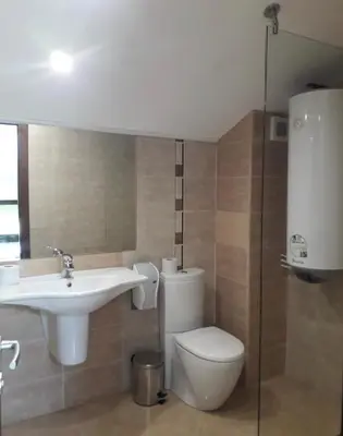 a bathroom with a toilet and a sink at Apartament by Zenit in Terra Complex B30 in Razlog