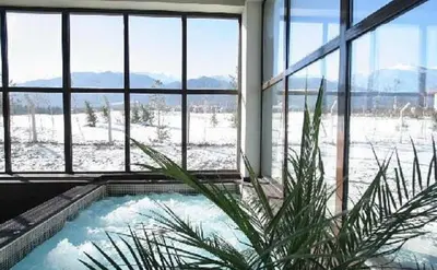 a jacuzzi tub in a building with a view of snow at Apartament by Zenit in Terra Complex B30 in Razlog