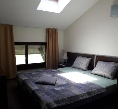a bedroom with a large bed and a window at Apartament by Zenit in Terra Complex B30 in Razlog