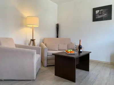 a living room with a couch and a table with fruit on it at Banderitsa Studio Bansko 2 in Bansko