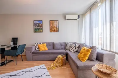 a living room with a couch and a table at Deja vu, Cozy & Quiet 1 BDR Apt Fast Wi-Fi in Sofia