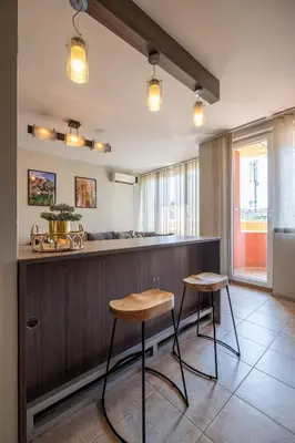 a bar with two stools and a counter in a room at Deja vu, Cozy & Quiet 1 BDR Apt Fast Wi-Fi in Sofia