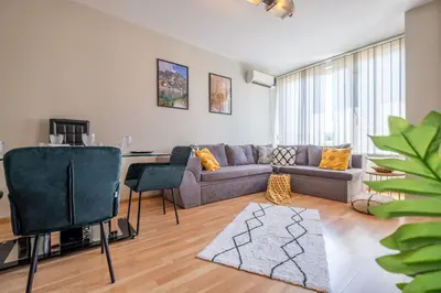 a living room with a couch and a table at Deja vu, Cozy & Quiet 1 BDR Apt Fast Wi-Fi in Sofia