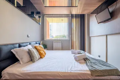 a bedroom with a large bed and a window at Deja vu, Cozy & Quiet 1 BDR Apt Fast Wi-Fi in Sofia